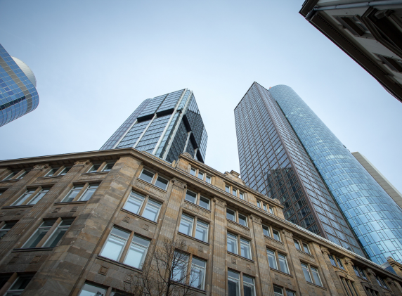 Low-angle view of modern skyscrapers and an older building in a city